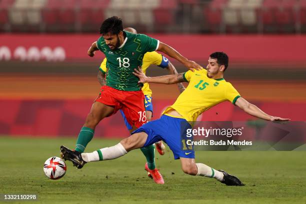 Eduardo Aguirre of Team Mexico is challenged by Nino of Team Brazil during the Men's Football Semi-final match between Mexico and Brazil on day...