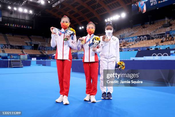 Silver medalist Xijing Tang of Team China, gold medalist Chenchen Guan of Team China and bronze medalist Simone Biles of Team United States pose with...