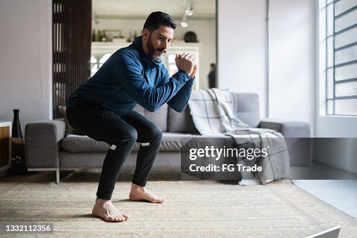 Mature man squatting at home Mature man squatting at home