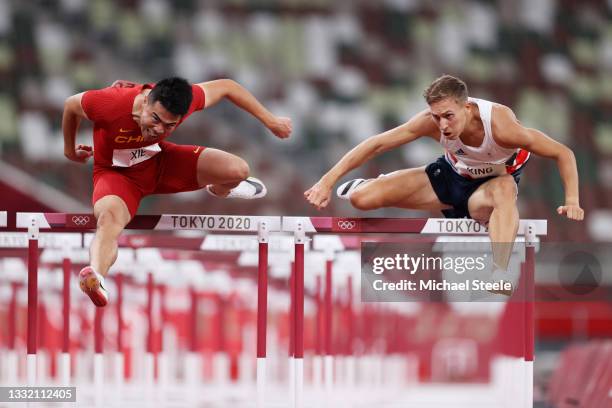 Wenjun Xie of Team China and David King of Team Great Britain compete in round one of the Men's 110m Hurdles heats on day eleven of the Tokyo 2020...