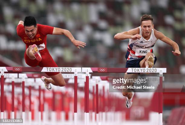 Wenjun Xie of Team China and David King of Team Great Britain compete in round one of the Men's 110m Hurdles heats on day eleven of the Tokyo 2020...