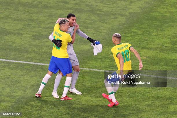 Santos, Reinier and Richarlison of Team Brazil celebrates their side's victory in the penalty shoot out after the Men's Football Semi-final match...