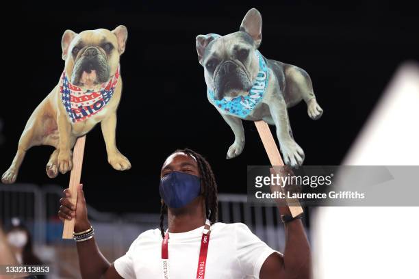 Member of the crowd holds signs with dogs during the Women's Balance Beam Final on day eleven of the Tokyo 2020 Olympic Games at Ariake Gymnastics...