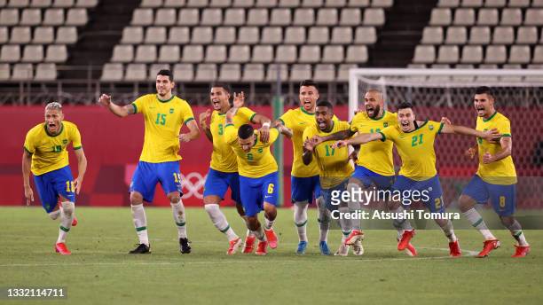 Players of Team Brazil celebrate their side's winning penalty in the penalty shoot out by Reinier of Team Brazil during the Men's Football Semi-final...