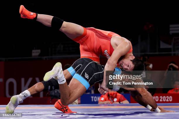 Shohei Yabiku of Team Japan competes against Mohammadali Geraei of Team Iran during the Men's Greco-Roman 77kg Bronze Medal Match on day eleven of...