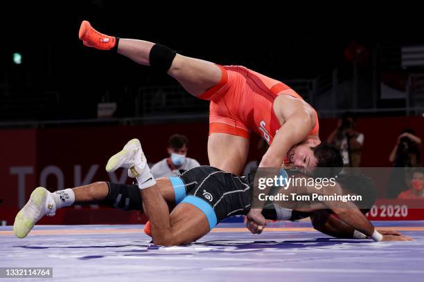 Shohei Yabiku of Team Japan competes against Mohammadali Geraei of Team Iran during the Men's Greco-Roman 77kg Bronze Medal Match on day eleven of...