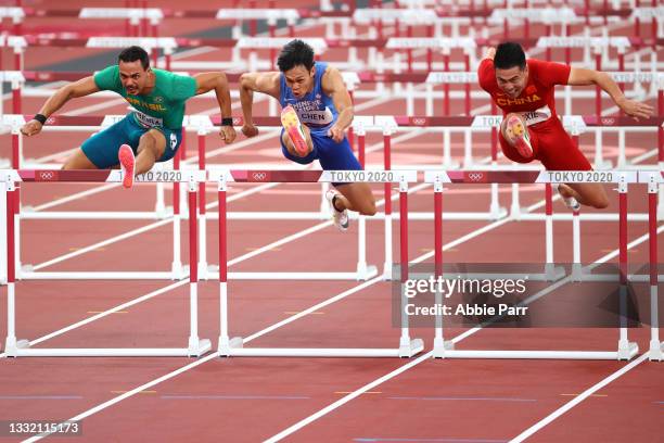 Rafael Pereira of Team Brazil, Kaeuei-Ru Chen of Team Taiwan and Wenjun Xie of Team China compete in round one of the Men's 100m Hurdles on day...