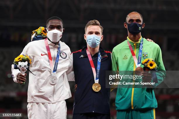 Silver medalist Rai Benjamin of Team United States, gold medalist Karsten Warholm of Team Norway and bronze medalist Alison dos Santos of Team Brazil...