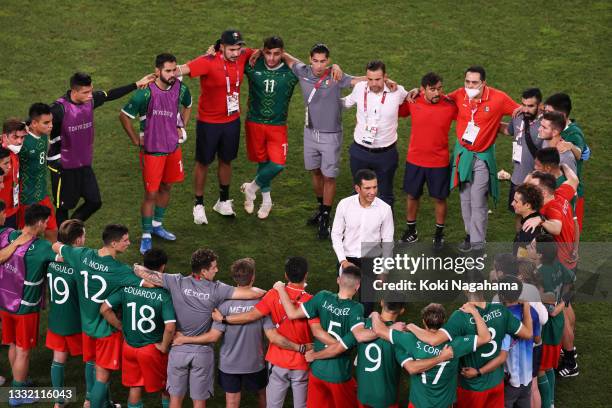 Jaime Lozano, Head Coach of Team Mexico gives his players instructions before the penalty shoot out during the Men's Football Semi-final match...