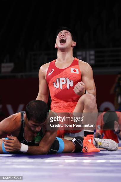 Shohei Yabiku of Team Japan celebrates defeating Mohammadali Geraei of Team Iran during the Men's Greco-Roman 77kg Bronze Medal Match on day eleven...