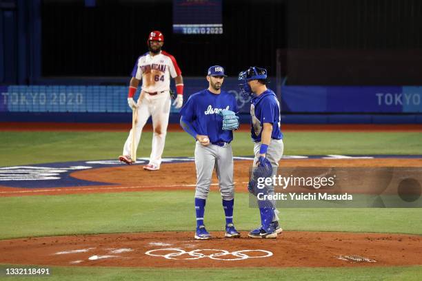 Josh Zeid of Team Israel speaks with Ryan Lavarnway on the mound against Team Dominican Republic during the knockout stage of men's baseball on day...