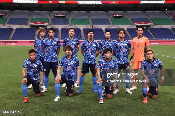 Players of Team Japan pose for a team photograph prior to the Men's Football Semi-final match between Japan and Spain on day eleven of the Tokyo 2020...