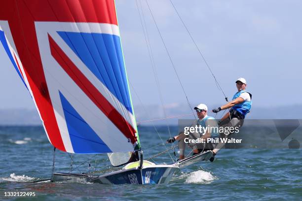 Dylan Fletcher and Stuart Bithell of Team Great Britain compete on their way to winning gold in the Men's Skiff 49er class medal race on day eleven...