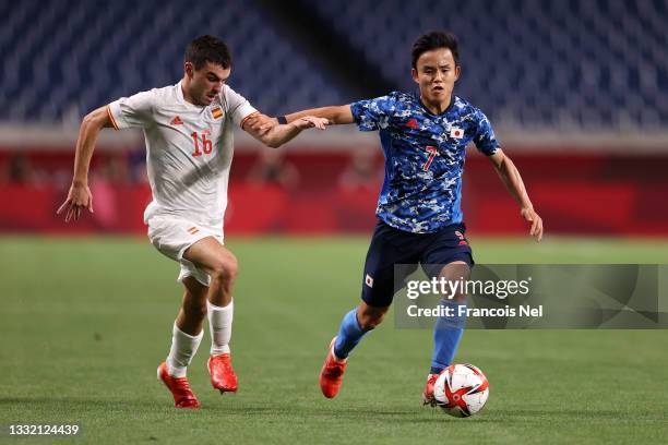 Takefusa Kubo of Team Japan battles for possession with Pedri Gonzalez of Team Spain during the Men's Football Semi-final match between Japan and...