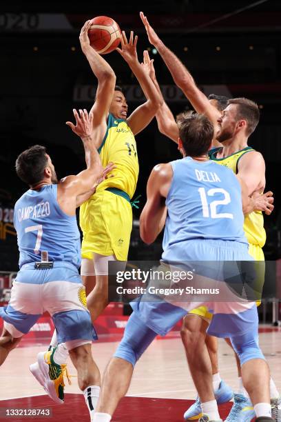 Dante Exum of Team Australia drives to the basket against Facundo Campazzo and Marcos Delia of Team Argentina during the first half of a Men's...