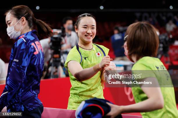 Ito Mima of Team Japan fistbumps her teammate Hirano Miu during their Women's Team Semifinal table tennis match on day eleven of the Tokyo 2020...