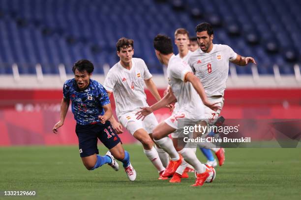 Reo Hatate of Team Japan is challenged by Mikel Merino of Team Spain during the Men's Football Semi-final match between Japan and Spain on day eleven...