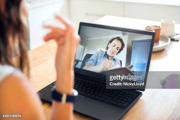 psychologist making notes during online session with patient - alternative therapy stock pictures, royalty-free photos & images