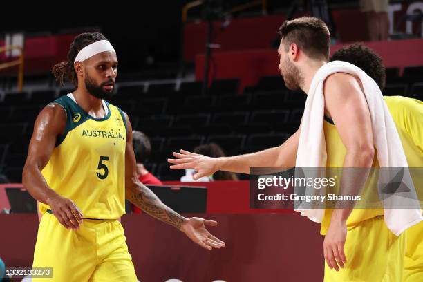 Patty Mills of Team Australia high-fives teammate Matthew Dellavedova as he makes his way to the bend during the first half of a Men's Basketball...