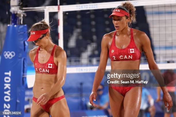 Heather Bansley and Brandie Wilkerson of Team Canada react against Team Latvia during the Women's Quarterfinal beach volleyball on day eleven of the...