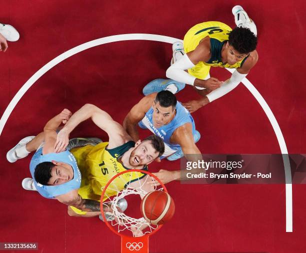Nic Kay and Matisse Thybulle of Team Australia watch for a rebound against Luis Scola and Gabriel Deck of Team Argentina during the first half of a...