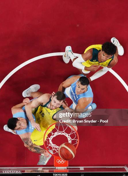 Nic Kay and Matisse Thybulle of Team Australia watch for a rebound against Luis Scola and Gabriel Deck of Team Argentina during the first half of a...