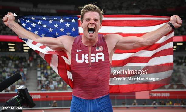 Christopher Nilsen of Team United States celebrates with his countries flag after winning the silver medal in the Men's Pole Vault Final on day...