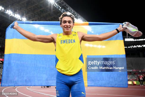 Gold medal winner Armand Duplantis of Team Sweden celebrates with his countries flag after the Men's Pole Vault Final on day eleven of the Tokyo 2020...
