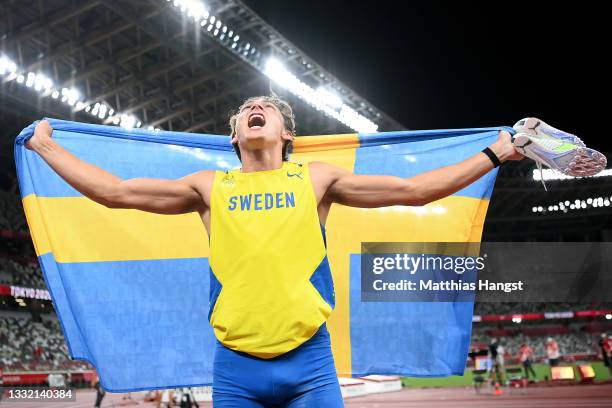 Gold medal winner Armand Duplantis of Team Sweden celebrates with his countries flag after the Men's Pole Vault Final on day eleven of the Tokyo 2020...