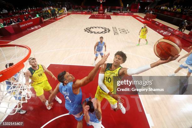 Matisse Thybulle of Team Australia drives to the basket against Luis Scola of Team Argentina during the second half of a Men's Basketball...