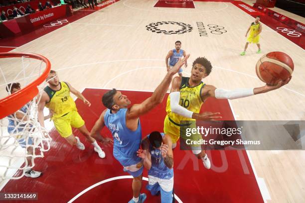 Matisse Thybulle of Team Australia drives to the basket against Luis Scola and Luca Vildoza of Team Argentina during the second half of a Men's...