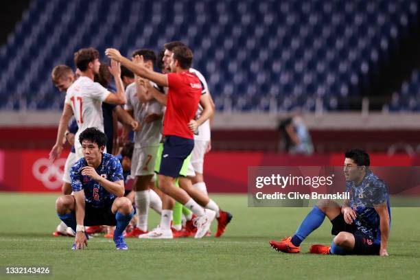Wataru Endo and Yuta Nakayama of Team Japan look dejected following defeat in the Men's Football Semi-final match between Japan and Spain on day...