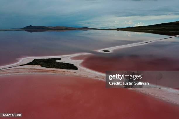 In an aerial view, evaporation ponds that are pinkish-red due to high salinity levels are visible on the north section of the Great Salt Lake on...