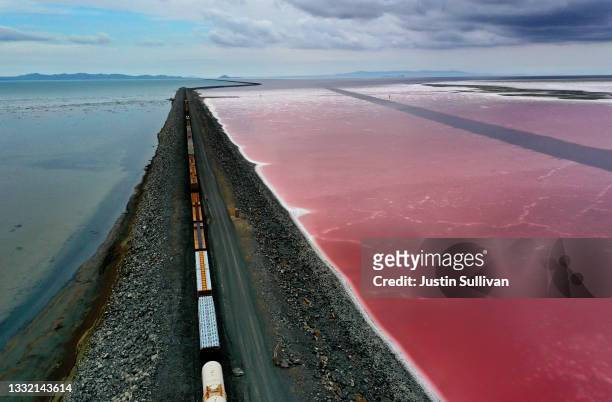 In an aerial view, a railroad causeway divides the Great Salt Lake on August 02, 2021 near Corinne, Utah. As severe drought continues to take hold in...
