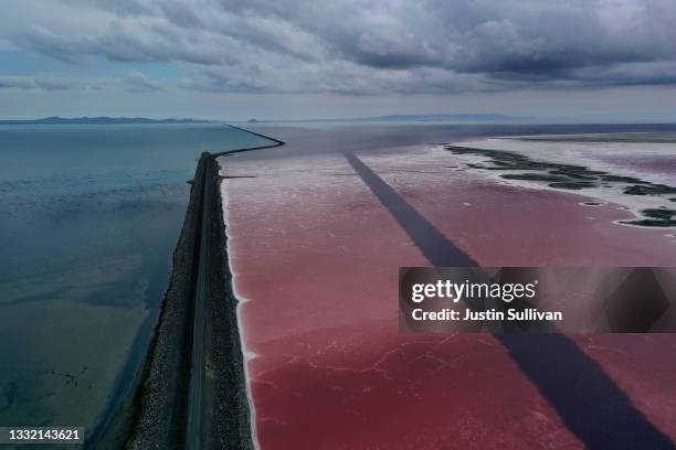 In an aerial view, a railroad causeway divides the Great Salt Lake on August 02, 2021 near Corinne, Utah. As severe drought continues to take hold in...