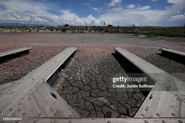 Boat docks sit on dry cracked earth at the Great Salt Lake's Antelope Island Marina on August 01, 2021 near Syracuse, Utah. As severe drought...