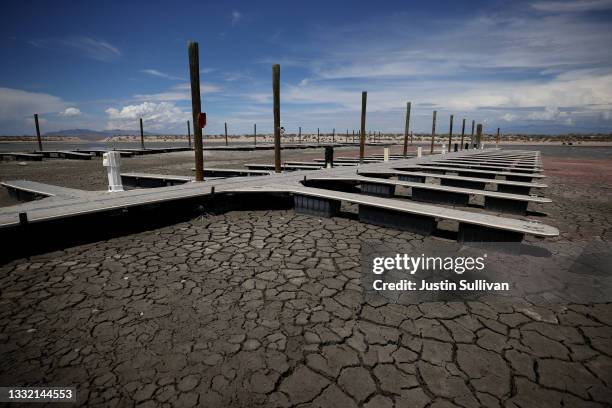 Boat docks sit on dry cracked earth at the Great Salt Lake's Antelope Island Marina on August 01, 2021 near Syracuse, Utah. As severe drought...