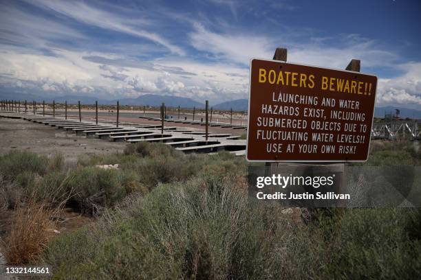 Sign is posted near boat docks that sit on dry cracked earth at the Great Salt Lake's Antelope Island Marina on August 01, 2021 near Syracuse, Utah....