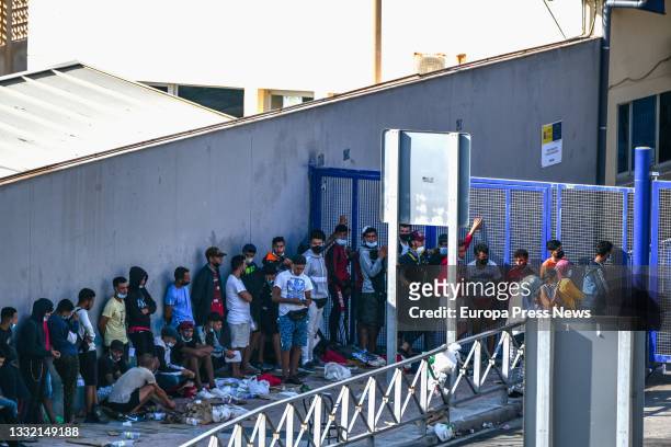 Hundreds of people, mostly Moroccans, queue at the asylum office located at the Tarajal border that separates Ceuta from Morocco, on 3 August 2021 in...