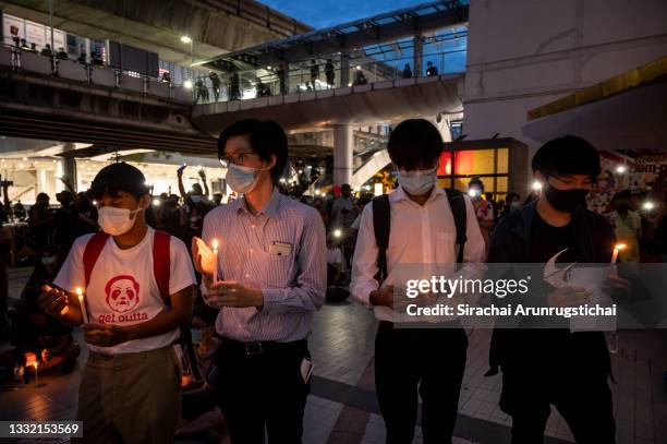 Protesters light candles to pay respect to the dead from the pandemic during the Harry Potter-themed protest at Bangkok Art and Culture Center in...