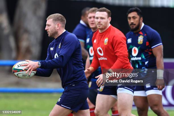 Finn Russell of British & Irish Lions looks to pass the ball to Sam Simmonds during a training session at Hermanus High School on August 03, 2021 in...