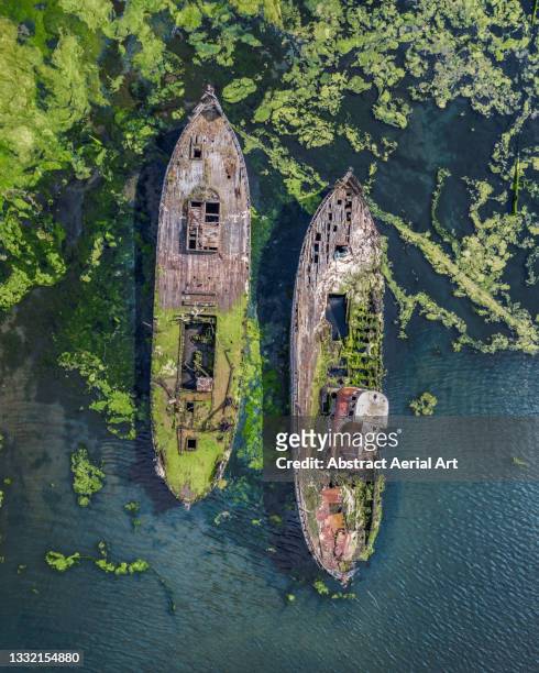 two abandoned ships run aground seen from directly above, united kingdom - abandoned boat stock pictures, royalty-free photos & images