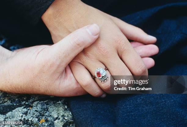 Close up of Viscount Althorp, Charles Spencer, holding the hand of his fiancee, British model Victoria Lockwood, displaying her engagement ring, in...