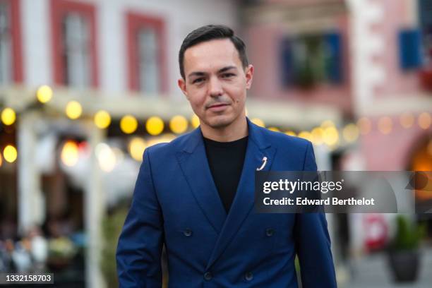 Emanuel Luhas wears a black t-shirt, a navy blue blazer jacket, matching navy blue suit pants, a silver brooch, before the Feeric Gala, during...