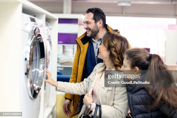 family buying a washing machine - appliance shop stock pictures, royalty-free photos & images