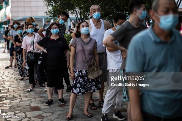 Residents line up for nucleic acid testing of COVID-19 on August 3, 2021 in Wuhan, Hubei Province, China. After local media reported seven cases of...