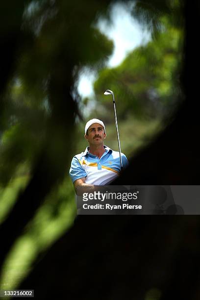 Geoff Ogilvy of the International Team watches his shot on the 13th hole during the Day Two Four-Ball Matches of the 2011 Presidents Cup at Royal...
