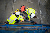 Safety team help employee accident falling scaffolding to the floor.