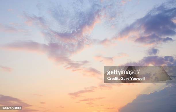 fluffy clouds at sunset - sky stock pictures, royalty-free photos & images
