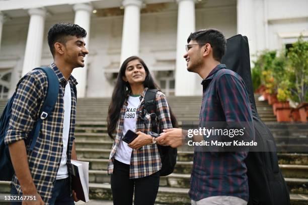 university student friends standing and talking in the university campus - インド系民族 ストックフォトと画像